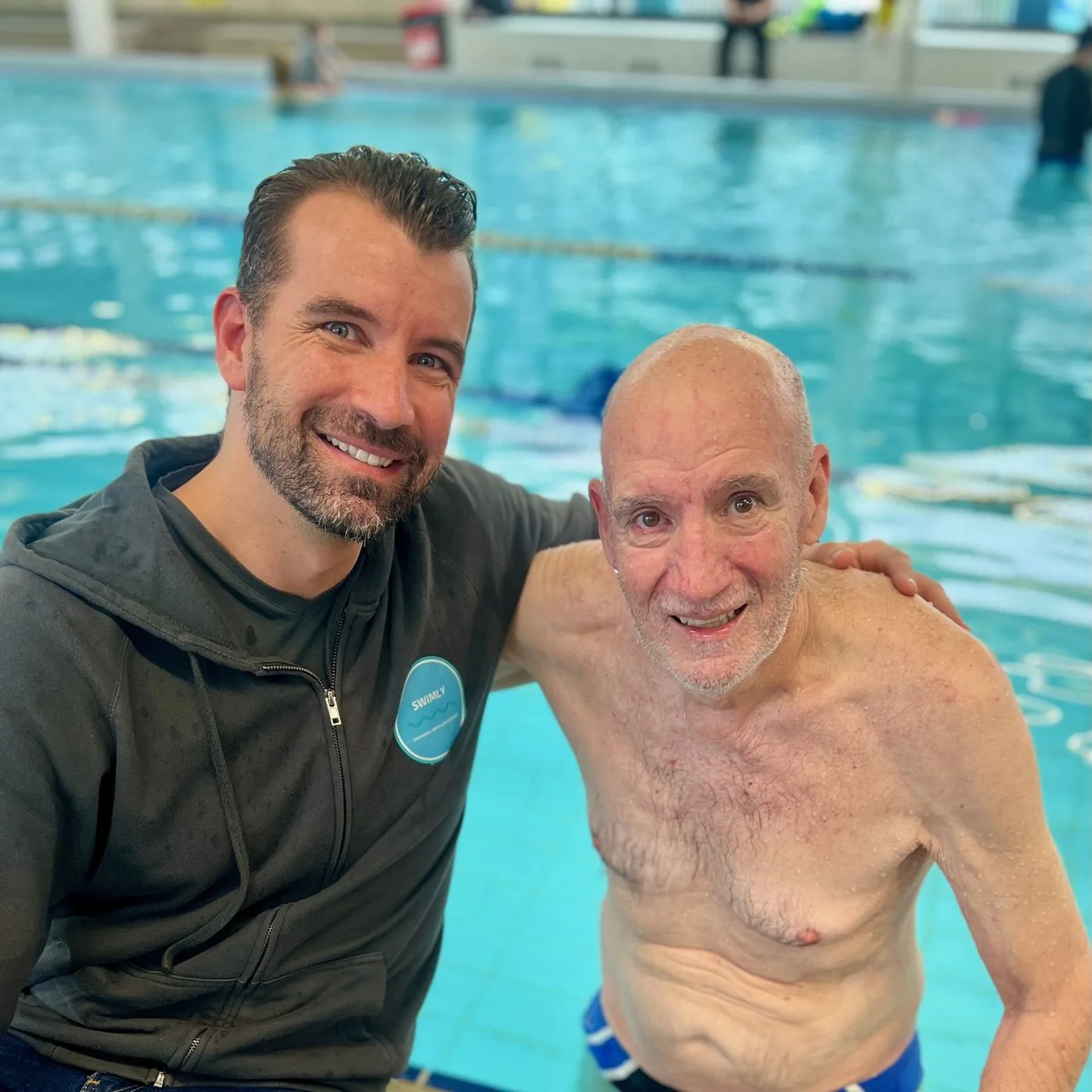 Jason Cram at the pool with an adult client after a session
